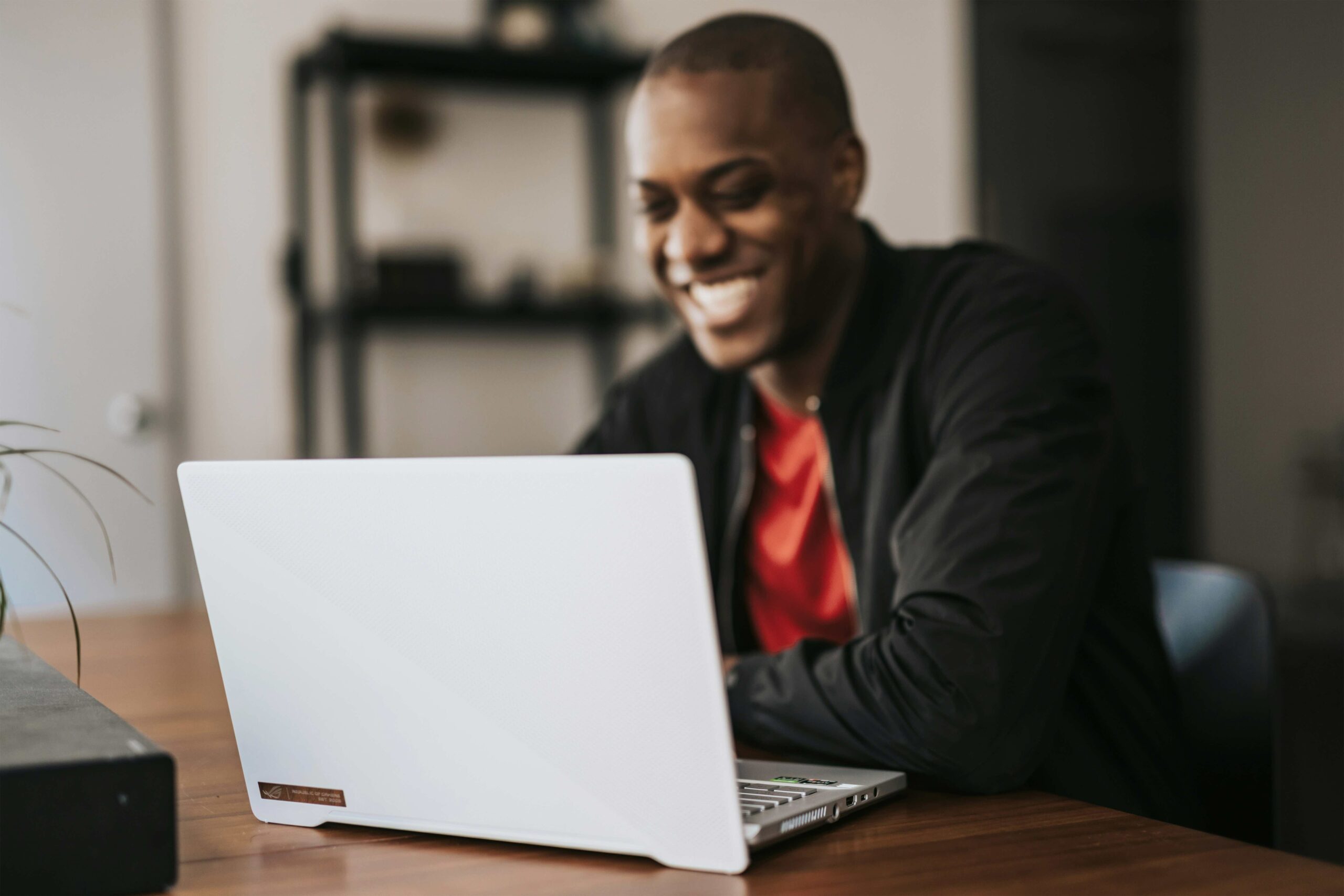 a guy enjoying his time at his laptop